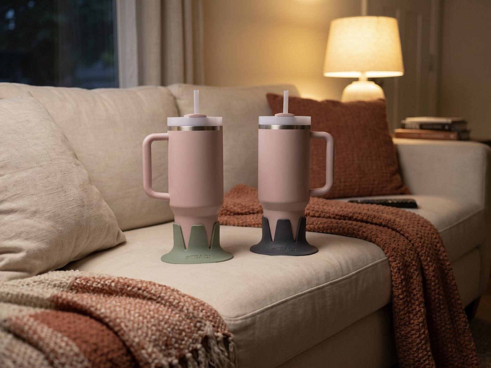 Two identical tumblers side by side, one in a sage holder and one in a charcoal holder.