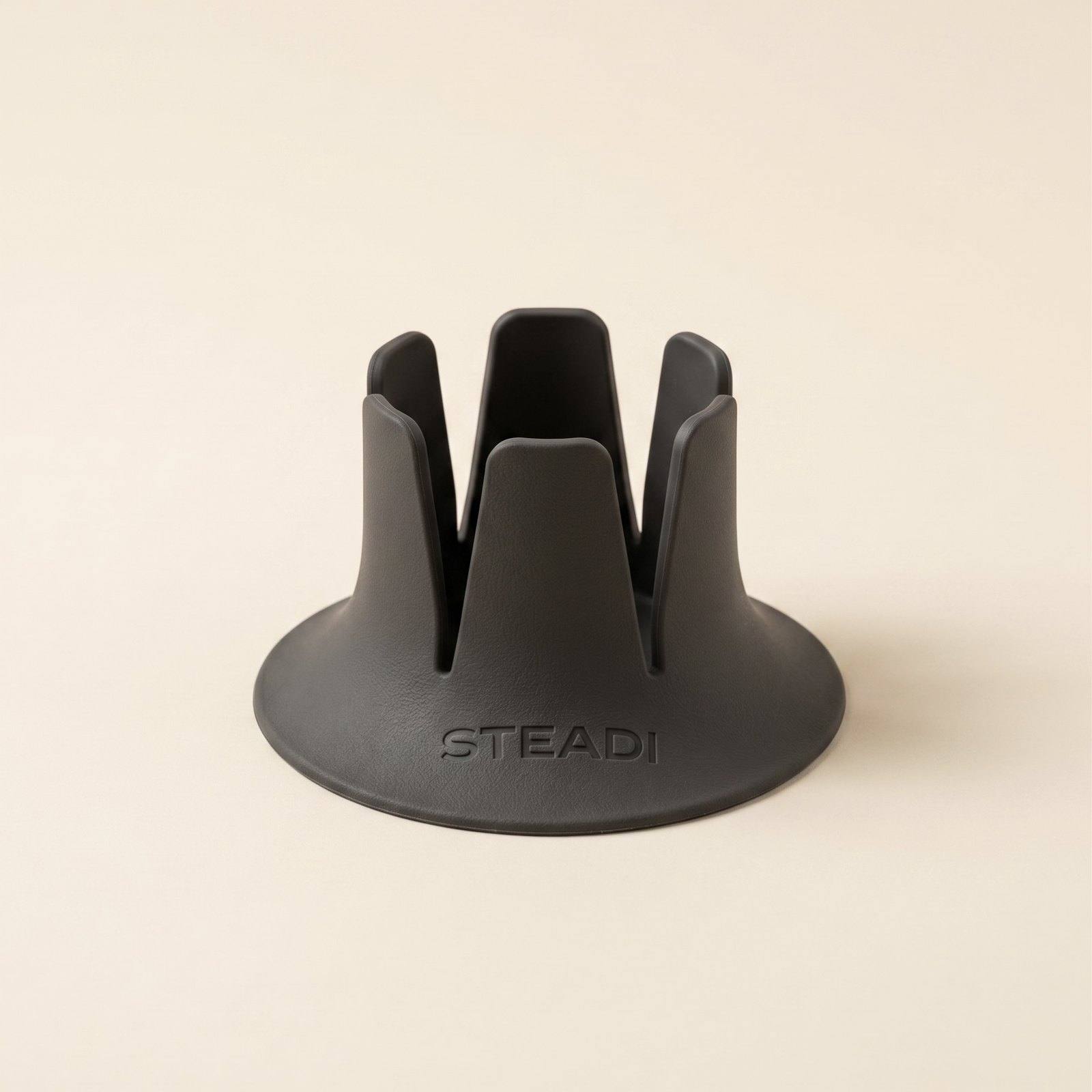 A charcoal drink holder shown from a three-quarter angle on warm paper.